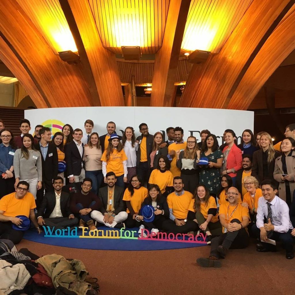 A group photo of young leaders posing at the World Forum for Democracy in France
