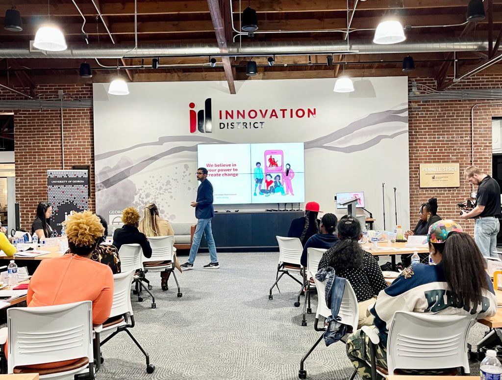 A photo of Nipuna Ambanpola presenting the IVolunteerNow app to a group